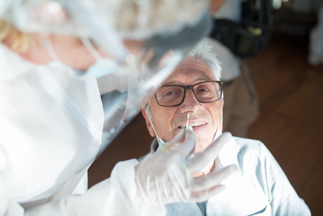 How to Get Rid of a Pimple Inside Your Nose: A Comprehensive Guide 1 Doctor gently cleaning their nose with a cotton swab.