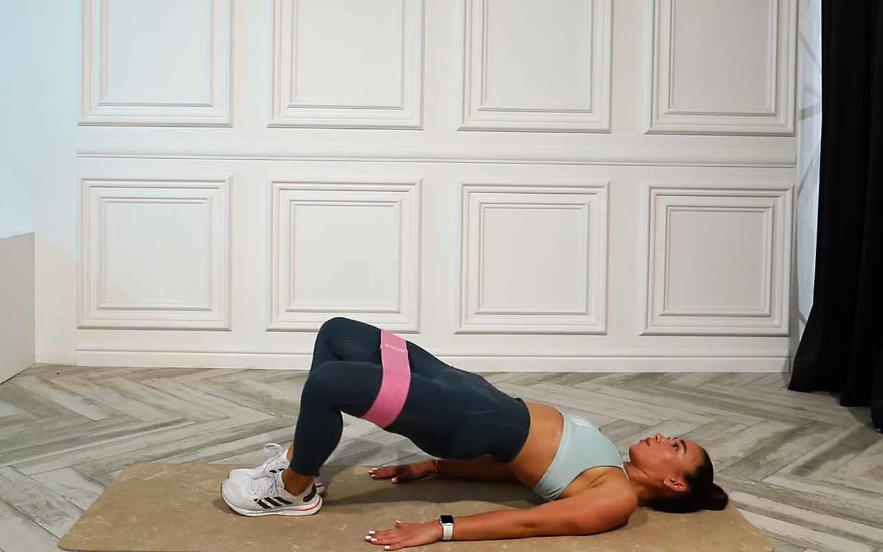 Woman using a resistance band Woman using a resistance band