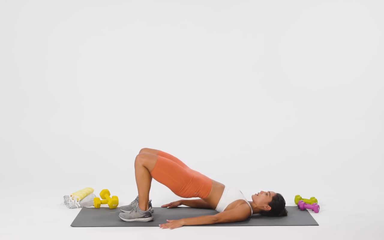 Woman performing a glute bridge Woman performing a glute bridge
